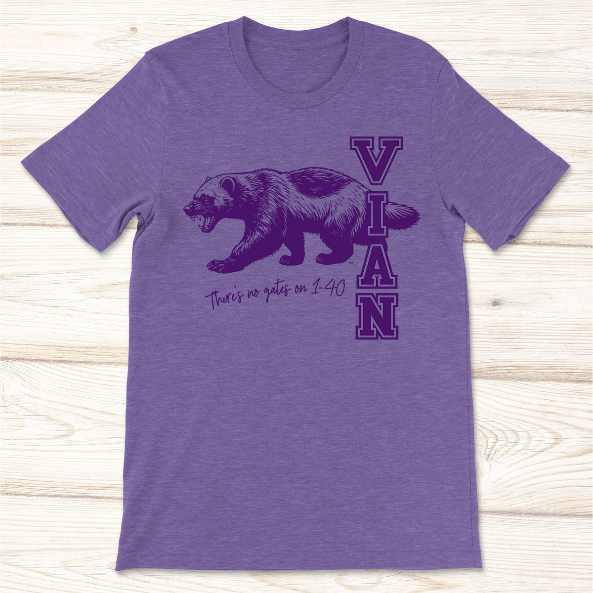 A heather purple tee with a snarling wolverine and Vian on the front.
